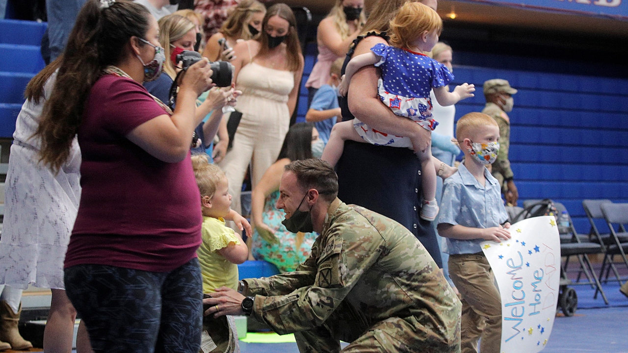 Captain Swasey Brown, a soldier with the 4th Battalion, 31st Infantry Regiment, 2nd Brigade Combat Team of the 10th Mountain Division, plays with his his daughter upon returning home from deployment in Afghanistan. Credit: Reuters Photo