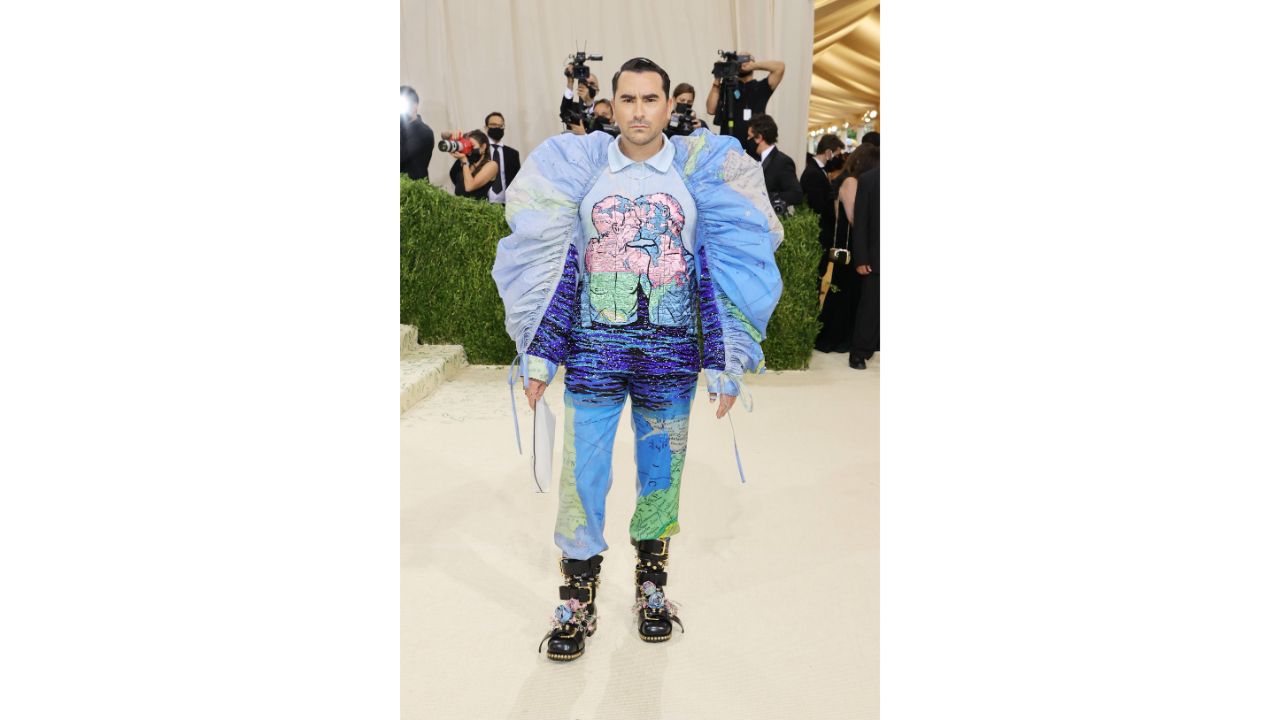 Dan Levy opted for a bold, puff-sleeved creation featuring an artwork on the front that showed two men kissing. Credit: AFP Photo