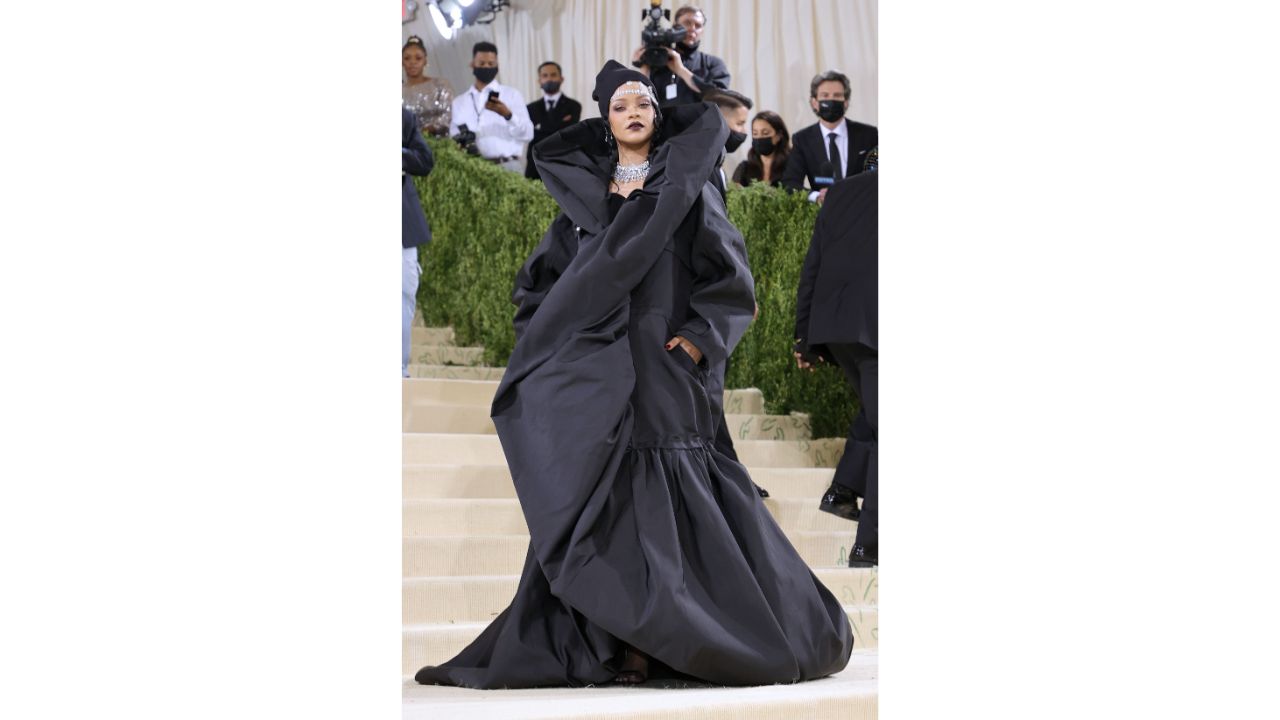 Rihanna, one of the most anticipated Met Gala stars, wore an oversized black coat dress, topped off with a beanie. Credit: AFP Photo