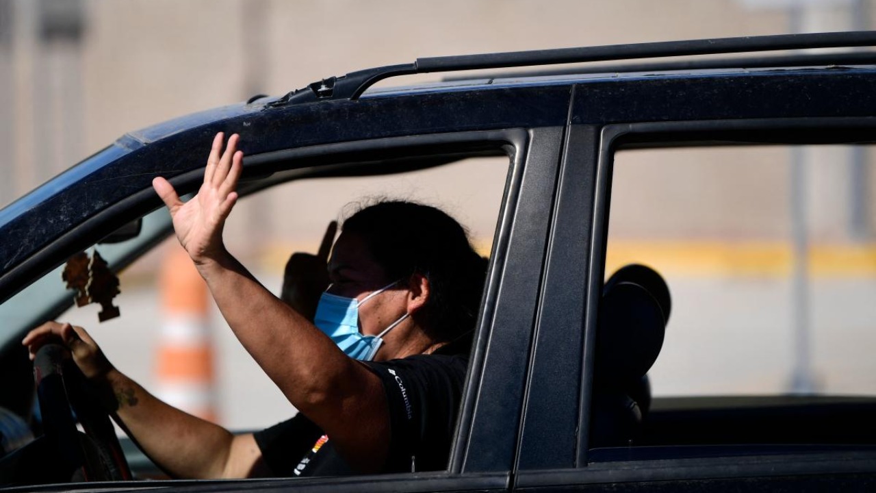 Cars wait in queue to cross the border during the reopening of the Ciudad Acuna, Coahuila - Del Rio, Texas, US, international bridge. Credit: AFP Photo