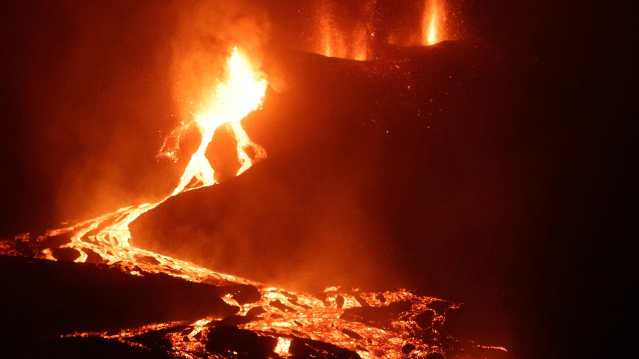 Lava flows and smoke rises following the eruption of a volcano on the Canary Island of La Palma, in Todoque, Spain on September 28, 2021. Credit: Reuters Photo