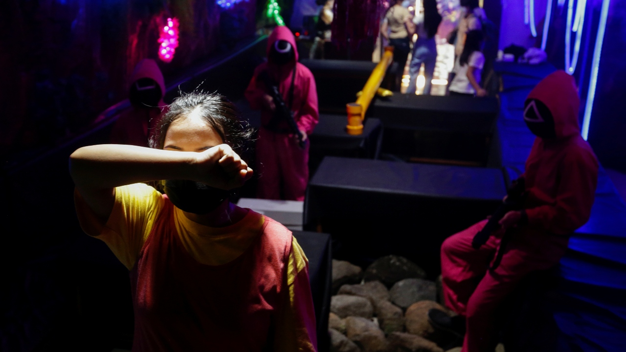A customer plays 'Red Light, Green Light' game from the Netflix show 'Squid Game' at Strawberry Cafe in Jakarta, Indonesia. Credit: Reuters Photo