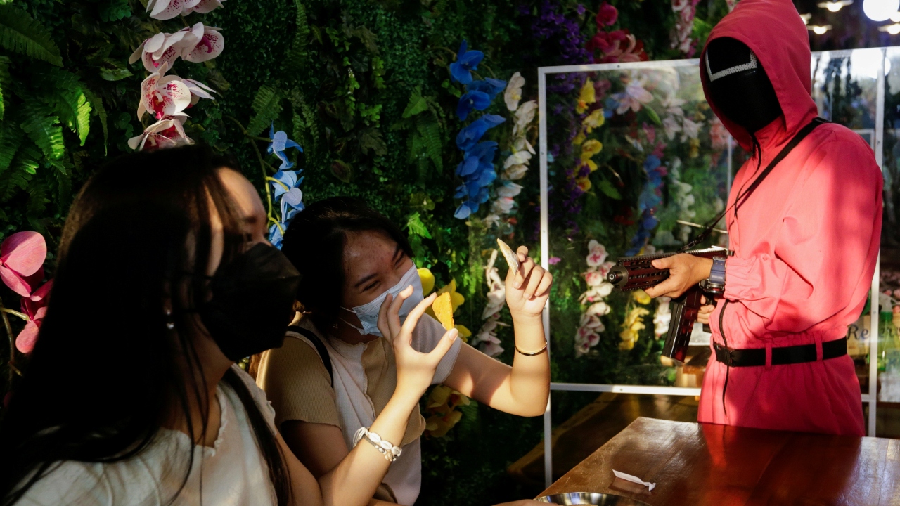 Customers play Squid Game's honeycomb toffee game at Strawberry Cafe in Jakarta, Indonesia. Credit: Reuters Photo
