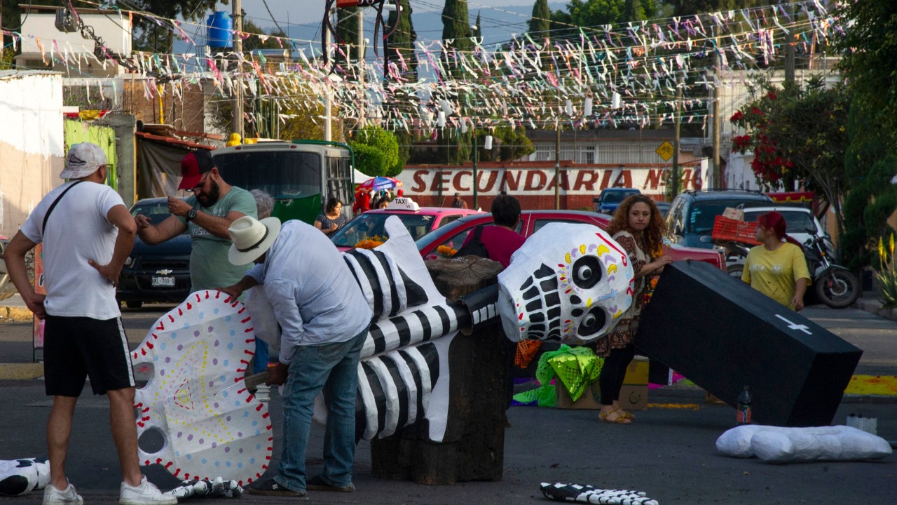 People make a skeleton out of cardboard on a street in Santa Cecilia neighbourhood in Mexico City ahead of the Day of the Dead celebrations. Credit: AFP Photo