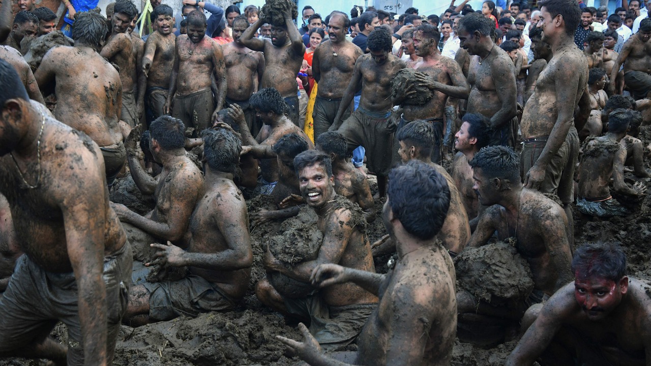Men fling cow dung at each other during the annual 'Gore Habba' festival, where people throw and smear each other with cow dung, in Gumatapura village situated some 180 Km south of Bangalore. Credit: AFP Photo