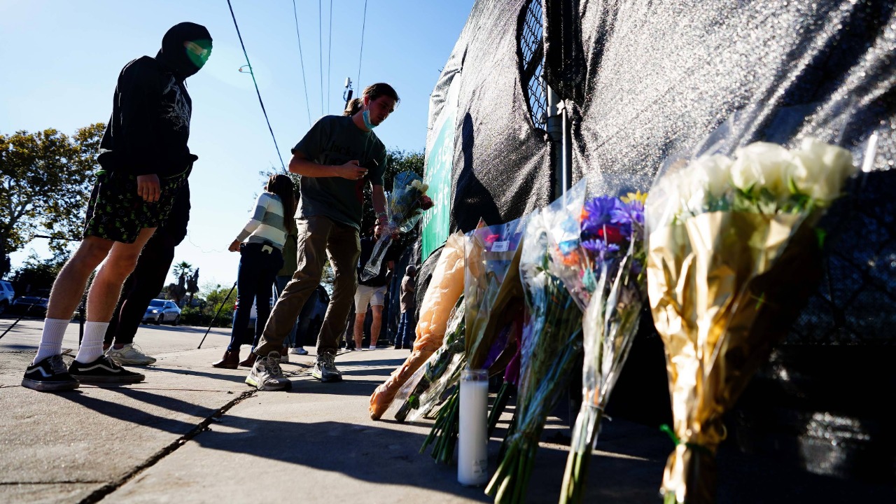 A festival patron is seen leading flowers outside of the canceled Astroworld festival at NRG Park on November 6, 2021 in Houston, Texas. Credit: Reuters Photo
