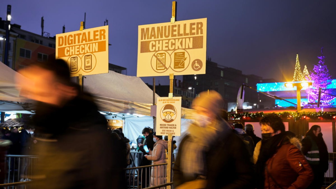 People queue to enter a Christmas market open only for visitors who are vaccinated or recovered from the coronavirus disease (Covid-19) at the red-light district