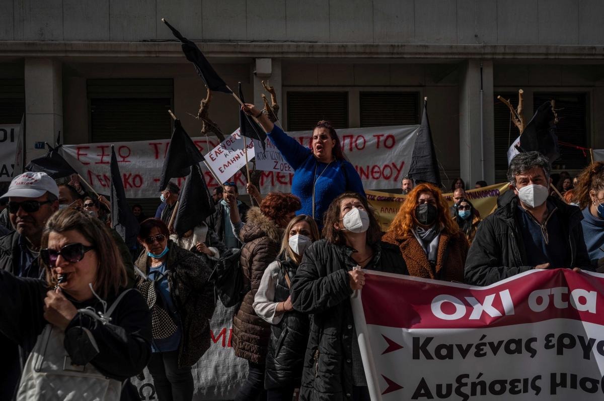 Healthcare workers, opposing mandatory Covid-19 coronavirus vaccination, shout slogans against the government during a protest outside the Greek Ministry of Health in Athens. Credit: AFP Photo