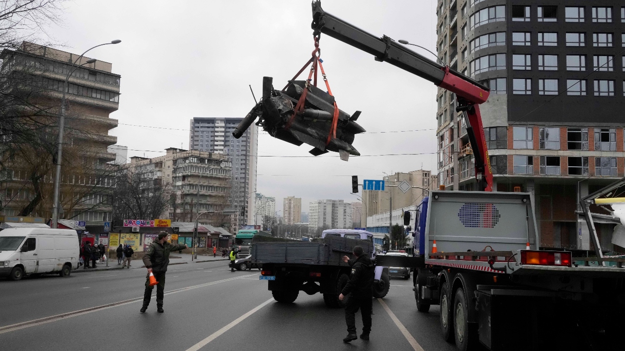 Workers load the debris of a rocket onto a truck the aftermath of Russian shelling in Kyiv, Ukraine. Credit: AP Photo