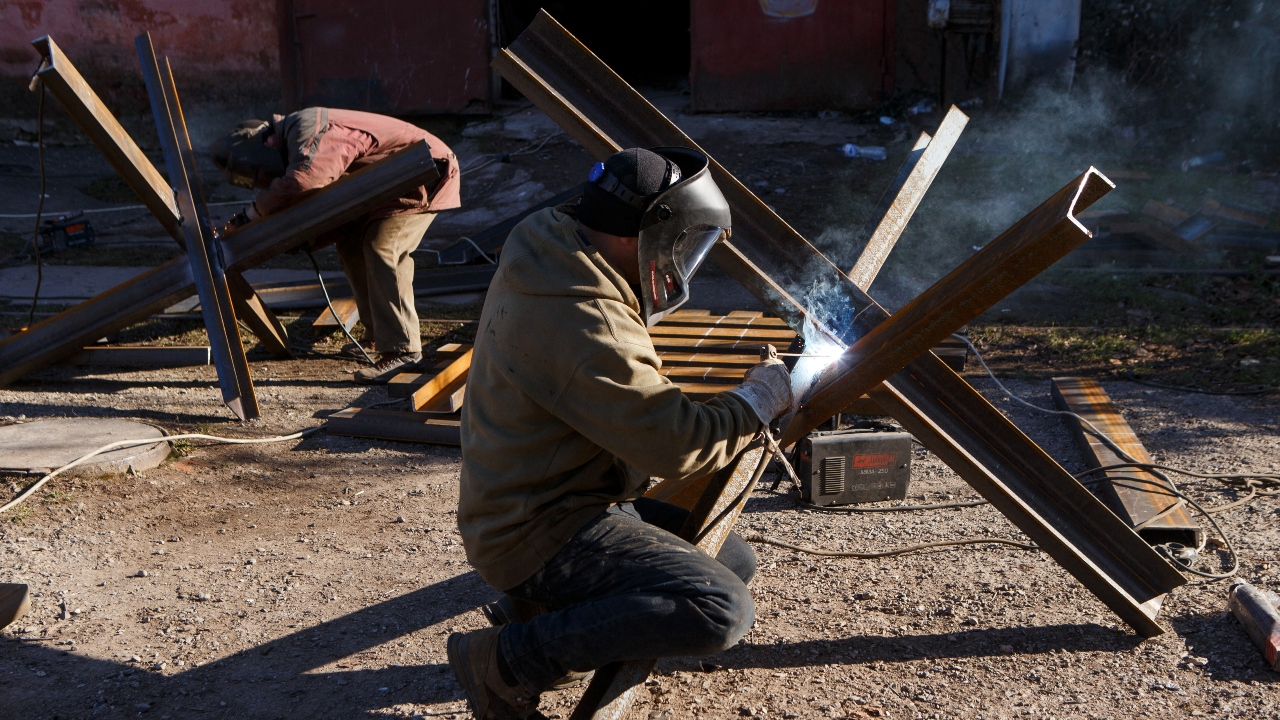 Local residents are seen making anti-tank obstacles to defend the city, in Ukraine. Credit: Reuters Photo