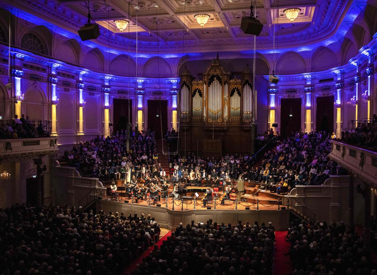A general view shows the Great Hall of the Concertgebouw illuminated in the colors of the Ukrainian flag during a concert, including Ukrainian pianist Anna Fedorova and Russian cellist Maya Fridman, performed to raise money for victims of the war in Ukraine, in Amsterdam. Credit: AFP Photo