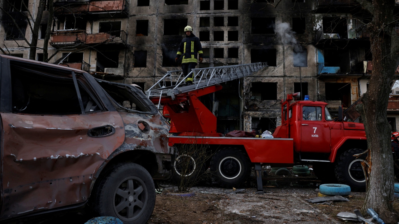A firefighter leaves a residential building that was hit by a shell in the Obolon district of Kyiv as Russia's invasion contiunes, Ukraine. Credit: Reuters Photo