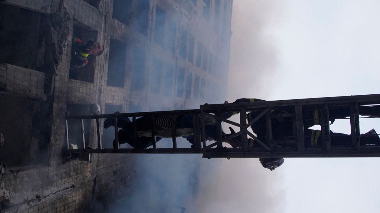 Rescuers help people to get out of a residential building that was damaged in an attack by Russia. Credit: Reuters Photo