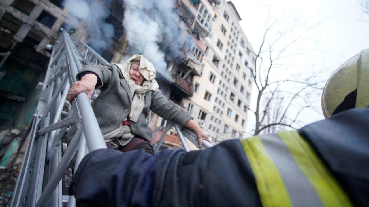 A woman is taken out of a residential building in Ukraine. Credit: Reuters Photo
