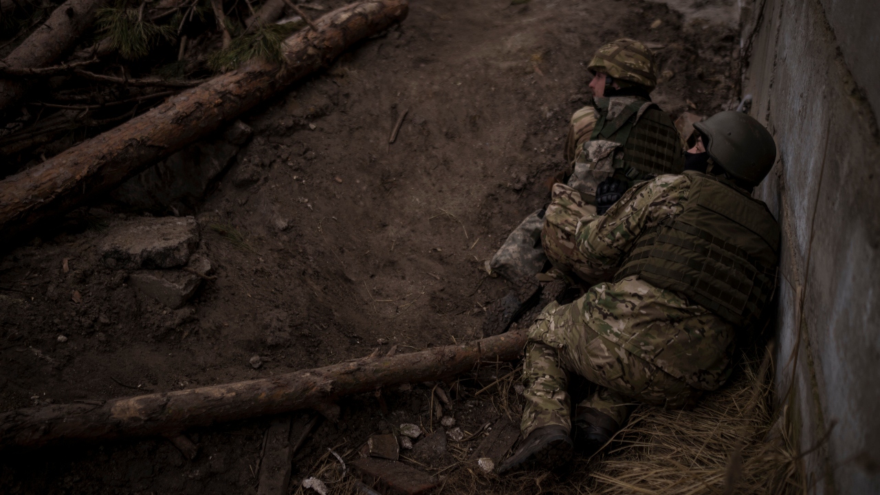 Ukrainian soldiers take cover from incoming artillery fire. Credit: AP Photo