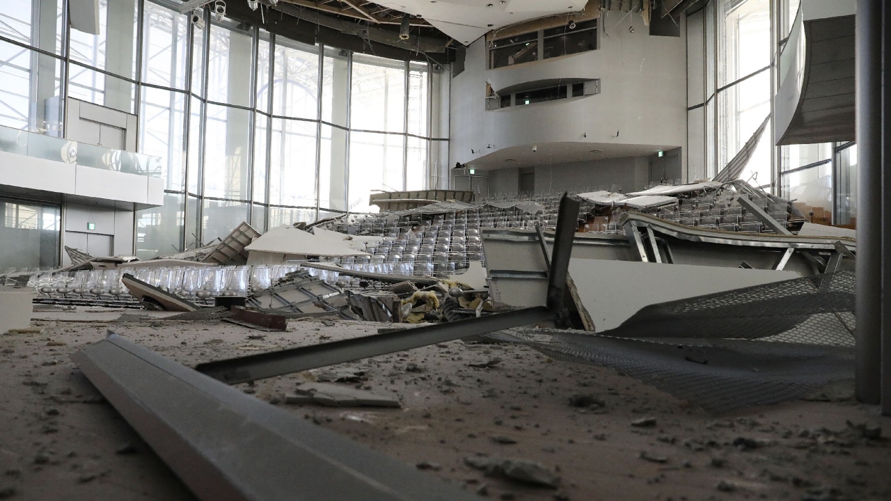 NHK footage showed broken walls of a department store building falling to the ground and shards of windows scattered on the street near the main train station in the inland prefectural capital of Fukushima city. Credit: AFP Photo