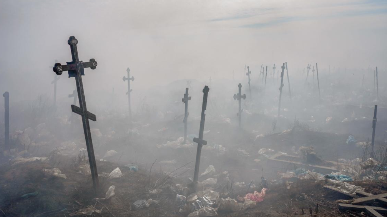 Crosses are pictured under smoke from a garbage in the cemetery of Mykolaiv, southern Ukraine. Credit: AFP Photo
