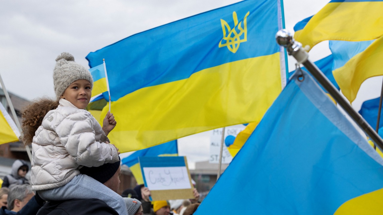Viktoria Shpylchak waves a flag on top of her father Ivan Shpylchak’s shoulders at a protest against Russia's invasion of Ukraine in Philadelphia, Pennsylvania, US. Credit: Reuters Photo