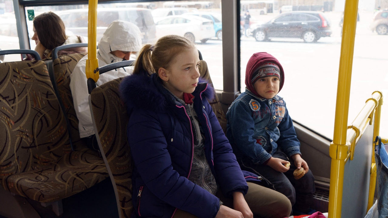 Children displaced families are seen in a bus as they're being transported to the Children's care home in Ukraine. Credit: Reuters Photo