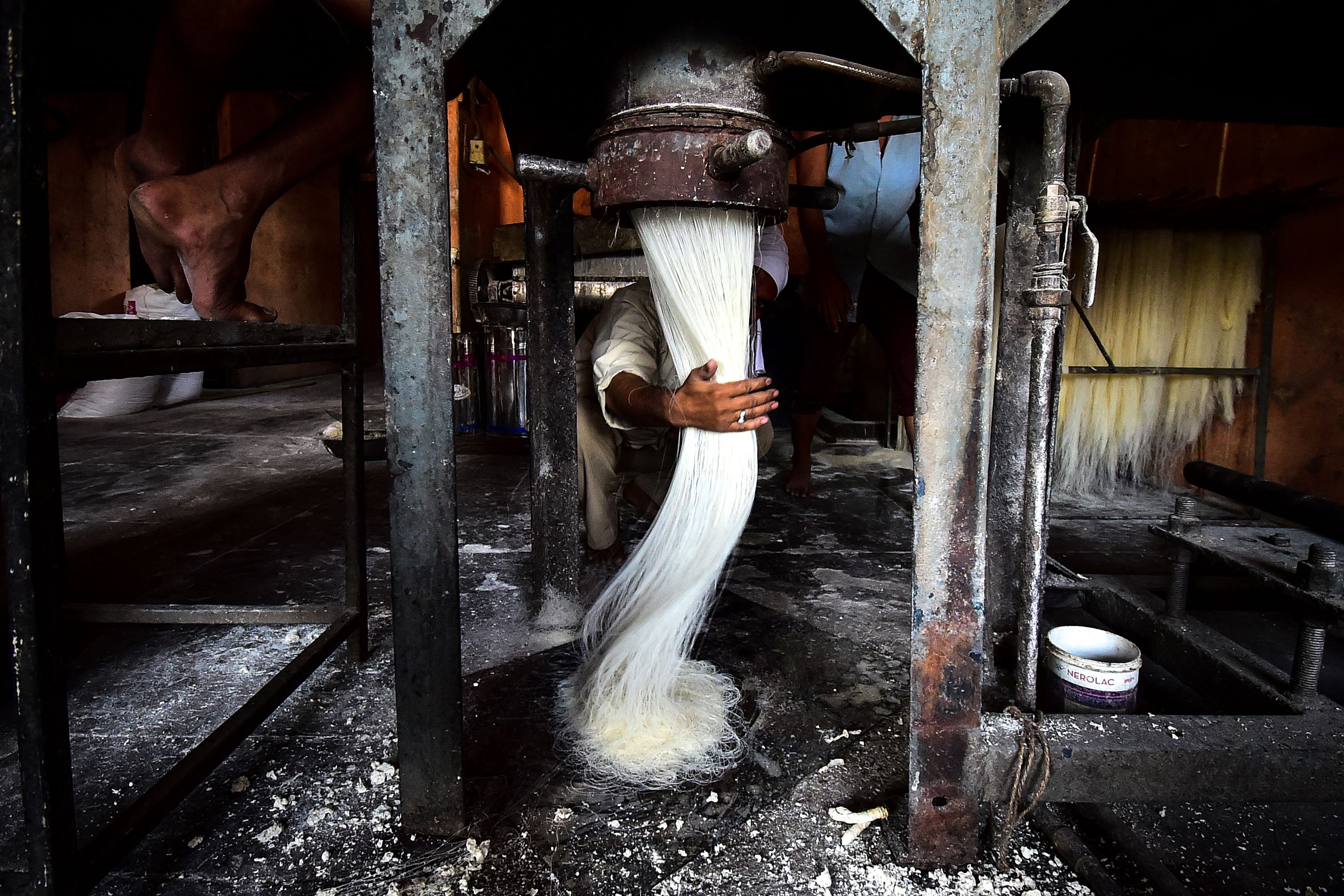 A worker prepares vermicelli which is used in making traditional sweet dishes popularly consumed during the holy month of Ramadan, at a factory in Allahabad. Credit: AFP Photo