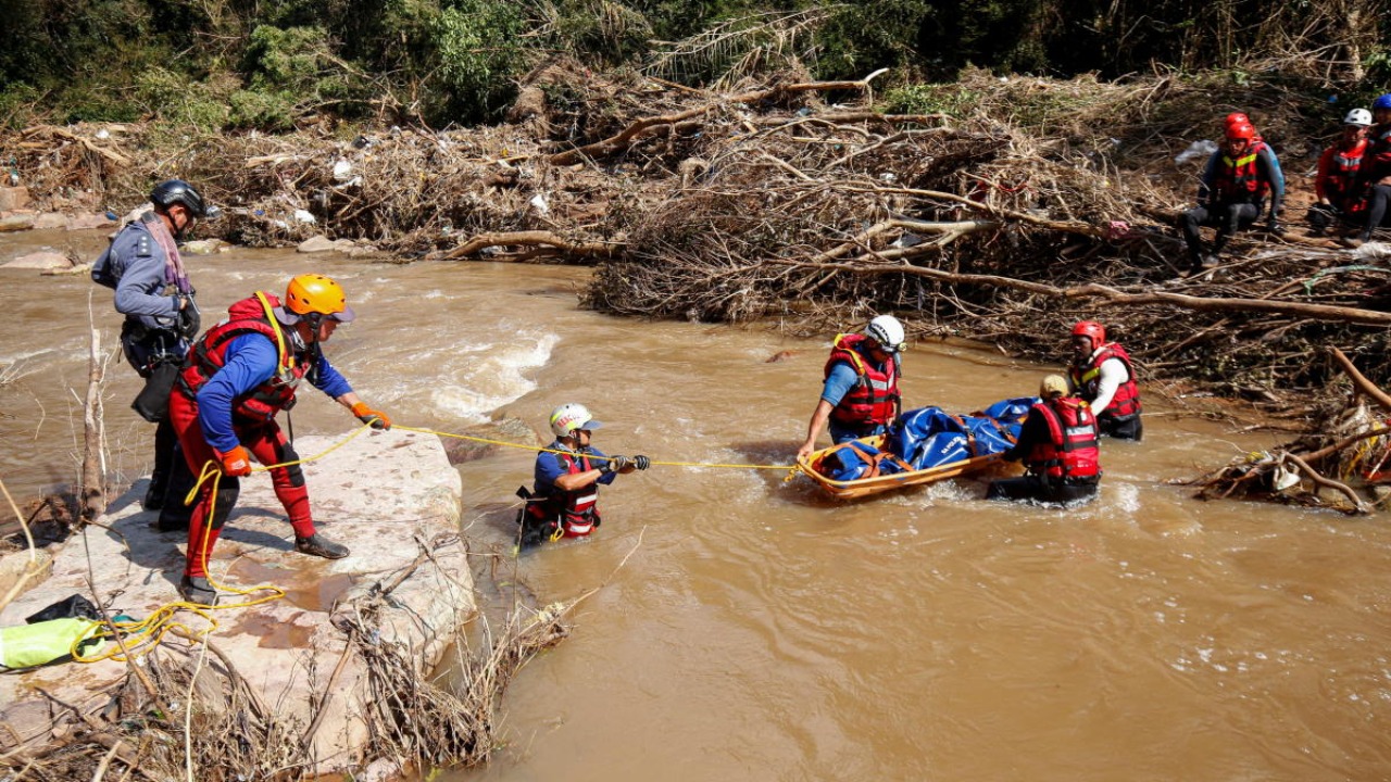 A search and rescue team prepares to airlift a body from the Mzinyathi River after heavy rains caused flooding near Durban, South Africa. Credit: Reuters photo