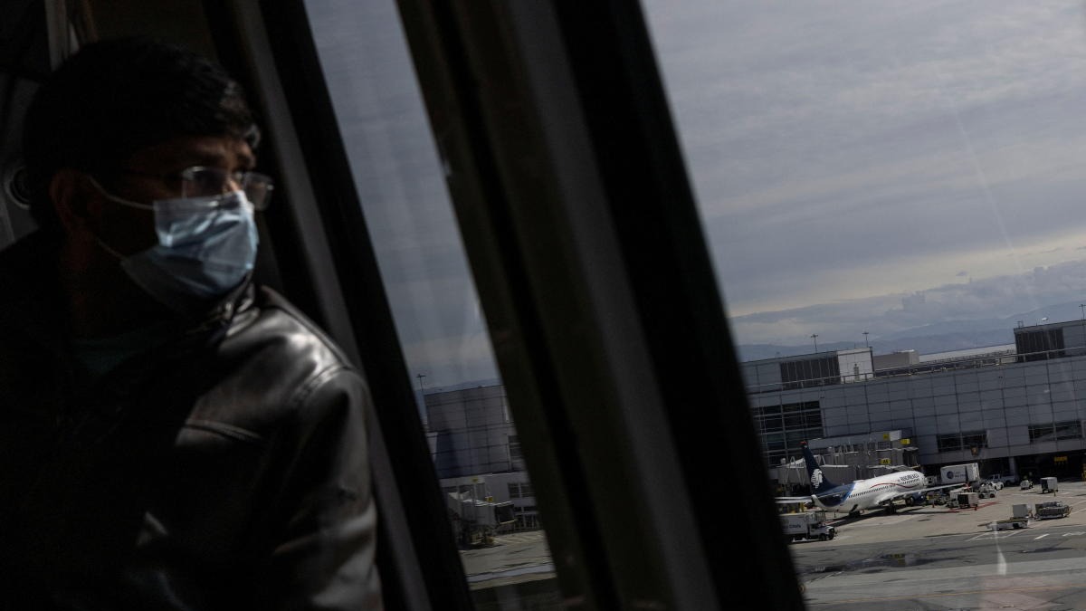 A man wearing a mask arrives at San Francisco international airport, after a federal judge in Florida struck down the CDC's public transportation masking order due to Covid-19. Credit: Reuters photo