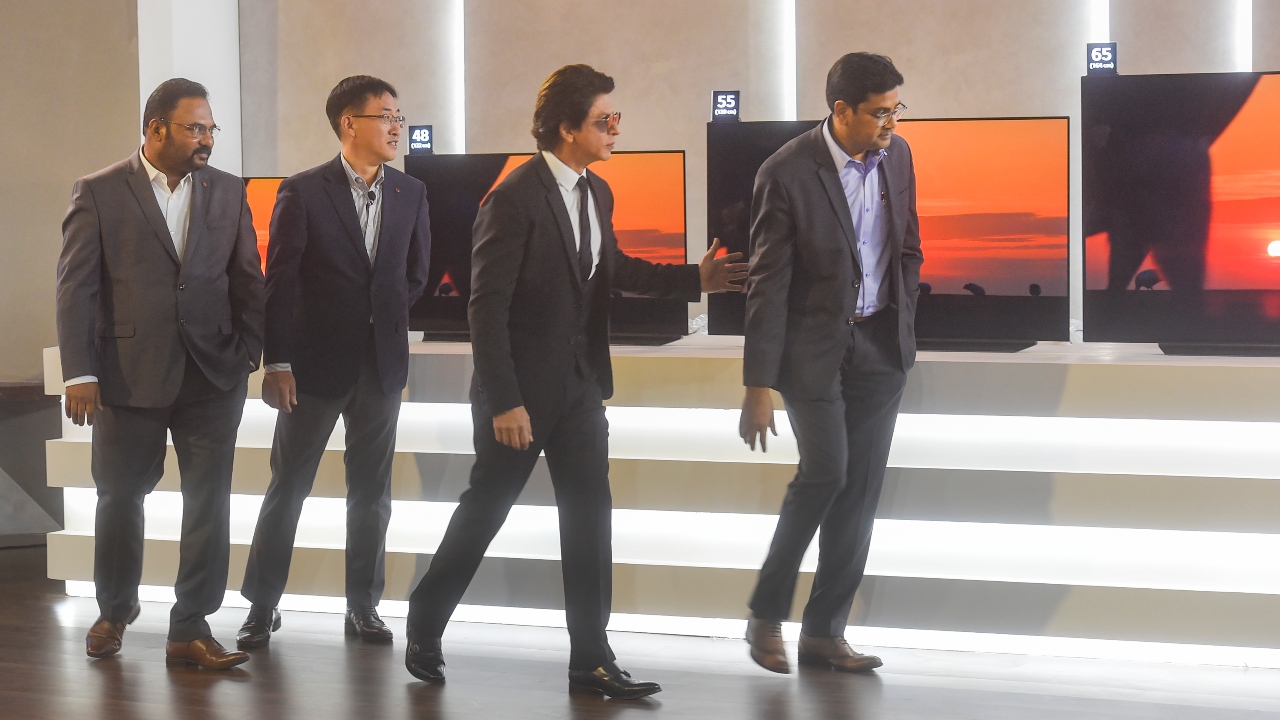 Dressed in a black suit, SRK was seen making a grand entry on the stage. Moments after the event, his photos and videos from the event were widely circulated on social media. Credit: AFP Photo