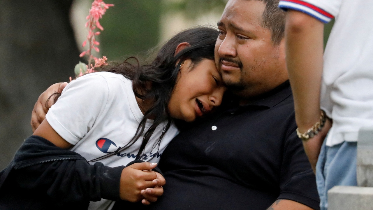 People get emotional as they wait outside the Willie de Leon Civic Center, where students had been transported from Robb Elementary School after a shooting, in Uvalde, Texas. Credit: Reuters Photo