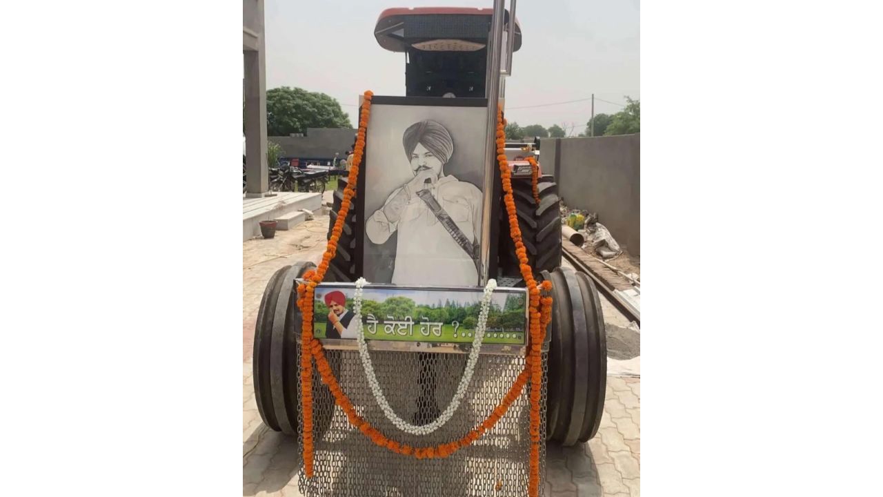 The singer's favourite tractor, which had figured in many of his music videos, was bedecked with flowers for his last ride to a family-owned field for the cremation. Credit: Special Arrangement