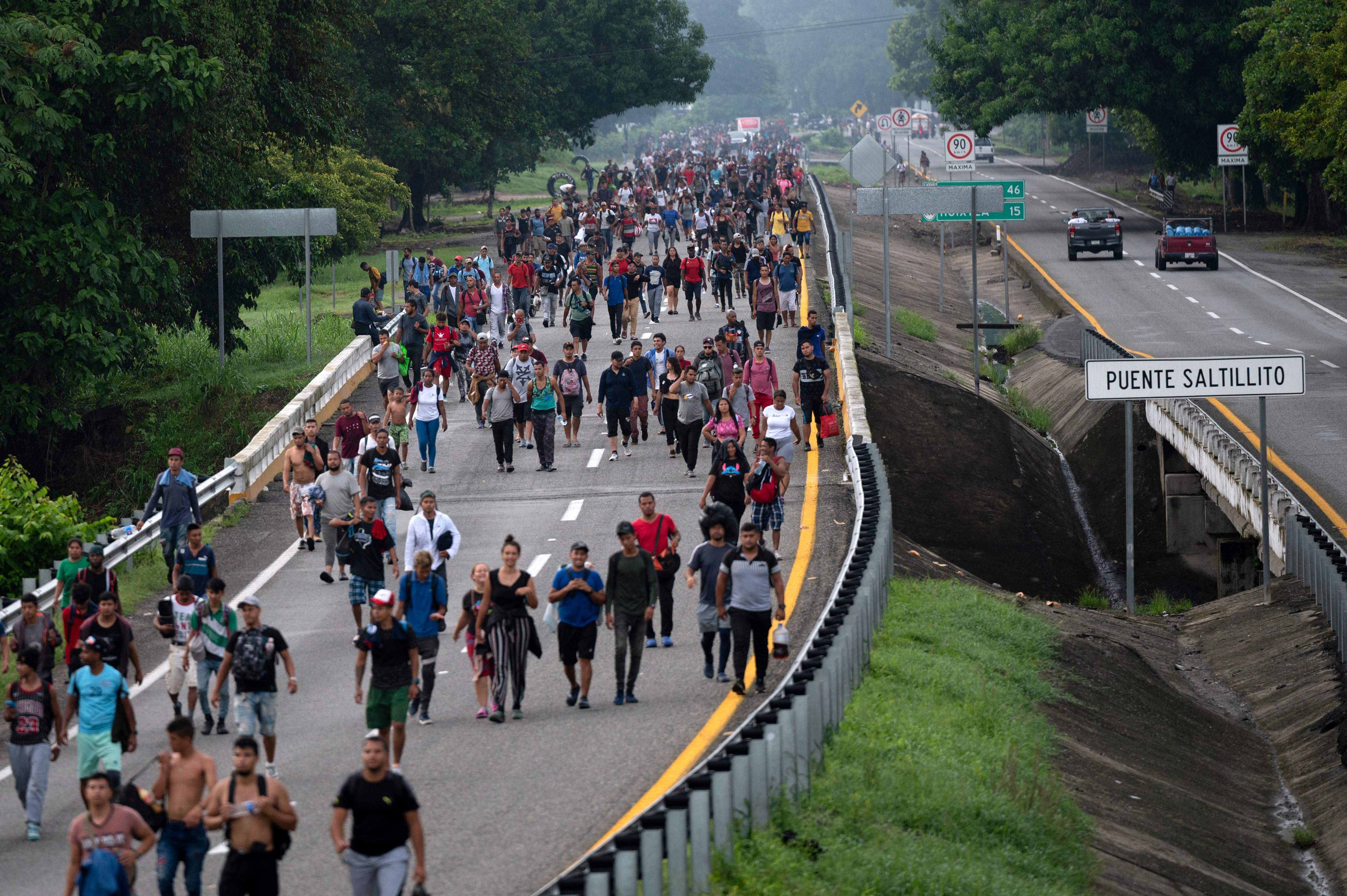 Migrants taking part in a caravan heading to the US, walk from Huixtla to Escuintla, Chiapas state, Mexico. Credit: AFP Photo