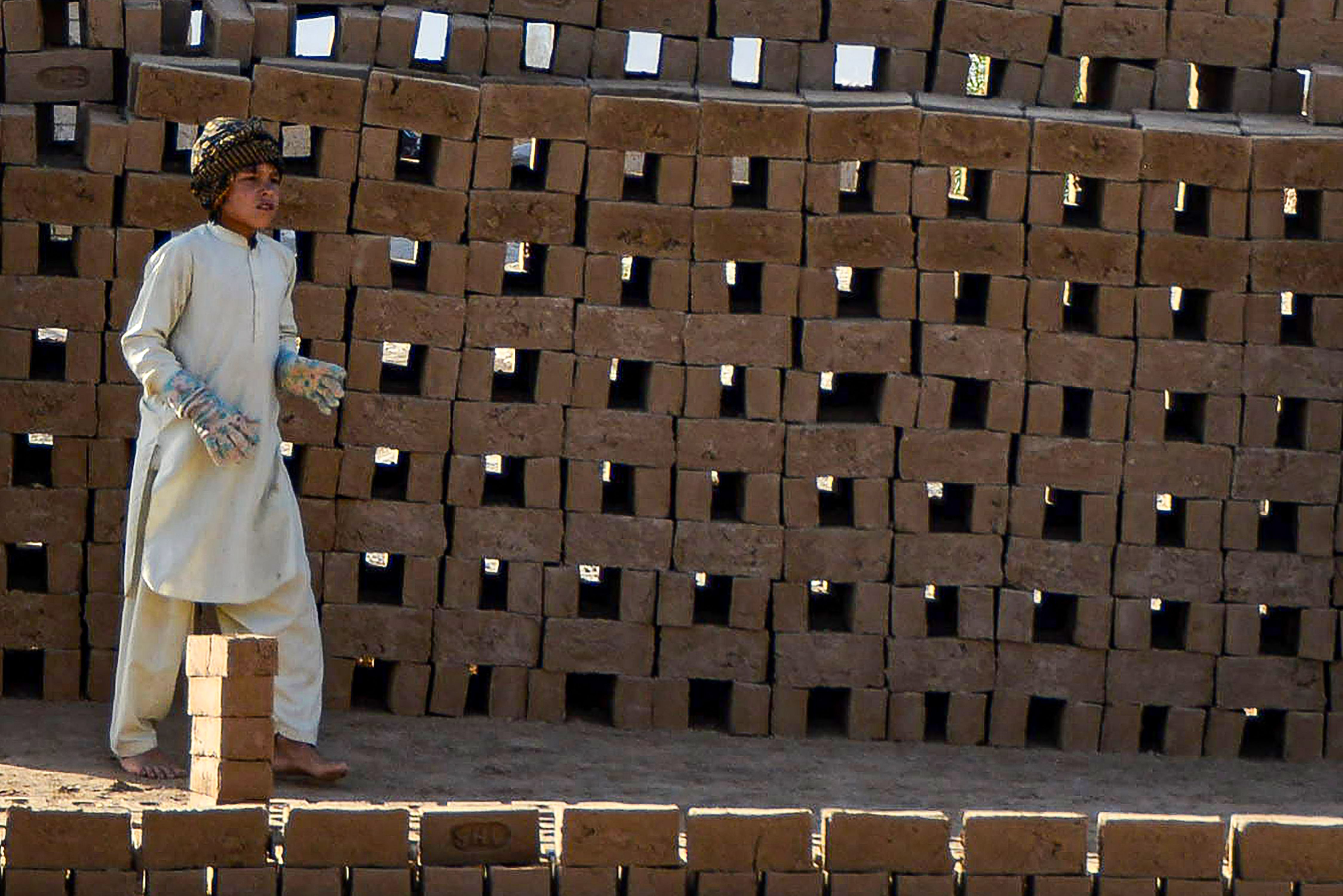 A boy works at a brick kiln on the outskirts of Kandahar. Credit: AFP Photo