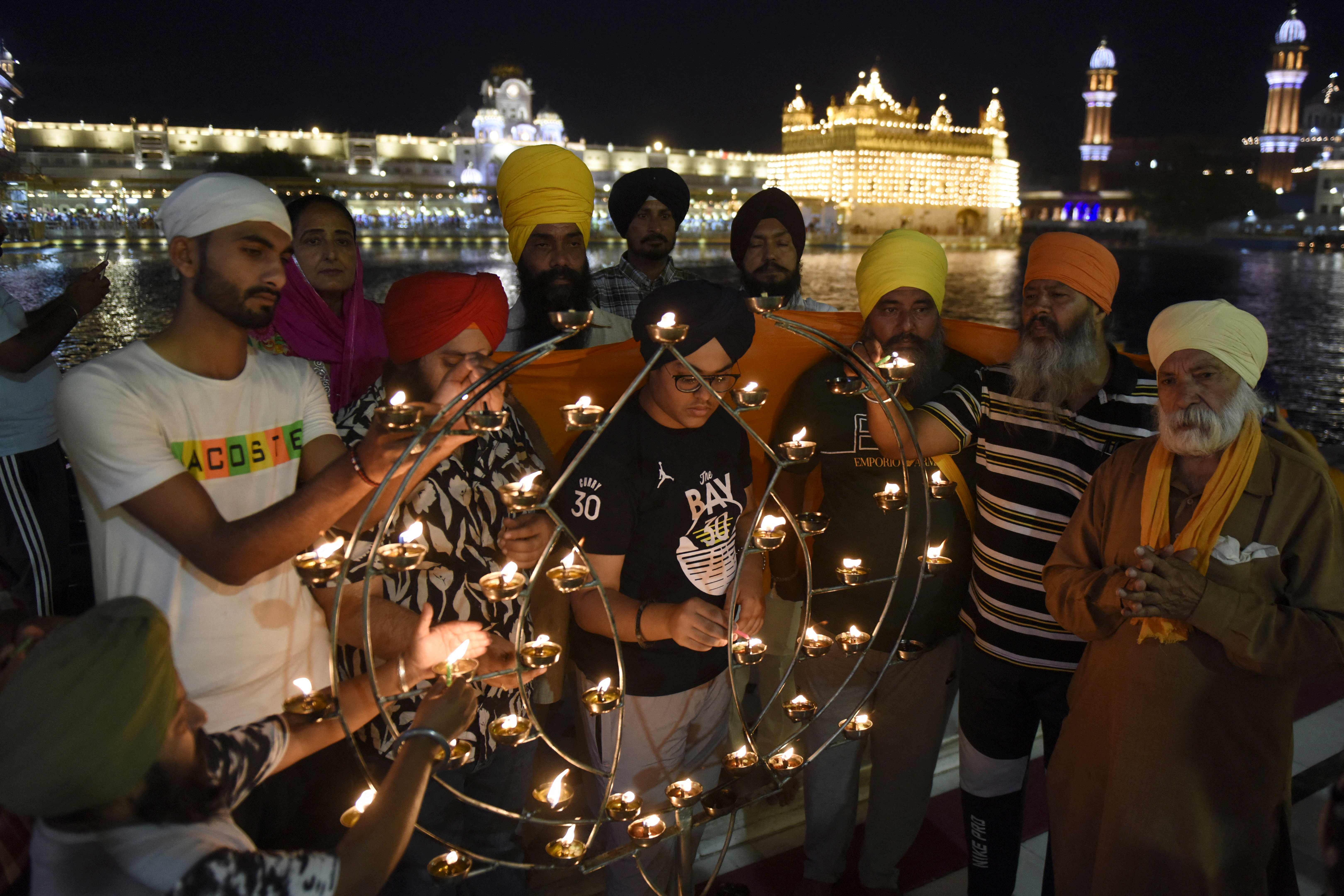 Sikh devotees light candles on the occasion of the birth anniversary of the sixth Guru Hargobind Singh at the Golden Temple in Amritsar. Credit: AFP Photo