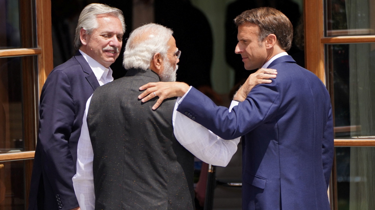 Prime Minister Narendra Modi and France's President Emmanuel Macron talk following a group photo, of leaders from the G7 and partner countries, at the G7 summit in Schloss Elmau, in the Bavarian Alps, Germany. Credit: Reuters Photo