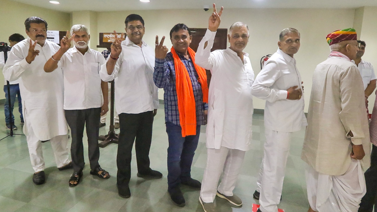 Rajasthan MLAs flash victory sign as they wait in a queue to cast their vote for the election of the President, at Rajasthan Assembly in Jaipur. Credit: PTI Photo