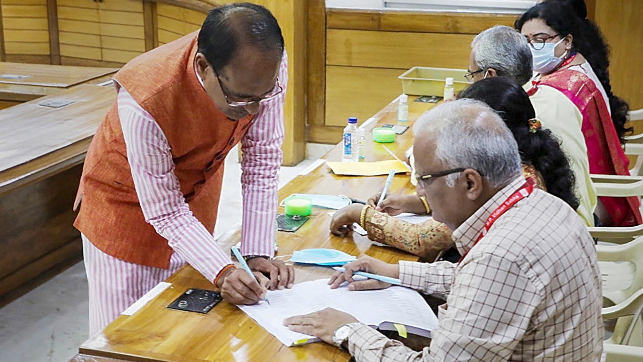 Madhya Pradesh Chief Minister Shivraj Singh Chouhan signs after casting his vote for the election of the President, in Bhopal. Credit: PTI Photo