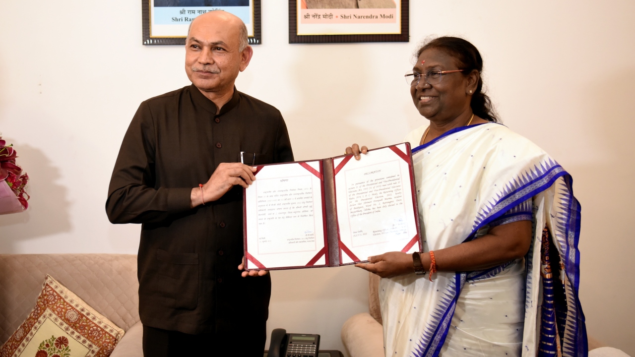 Returning Officer of Presidential Elections, Rajya Sabha Secretary General PC Modi handed over the certificate of victory to the newly elected President Droupadi Murmu. Credit: PTI Photo