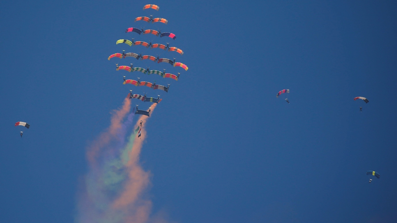 Aerobatic paratroopers perform stunts at the Pyramids Air Show 2022, at the Pyramids Plateau in Giza, Egypt. Credit: Reuters Photo