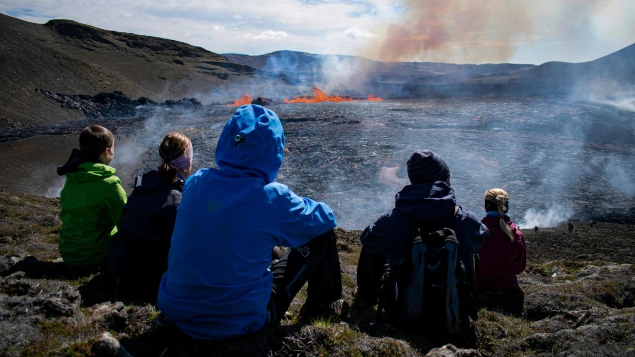 People visit the scene of the newly erupted volcano taking place in Meradalir valley, near mount Fagradalsfjall, Iceland on August 4, 2022. Credit: AFP Photo