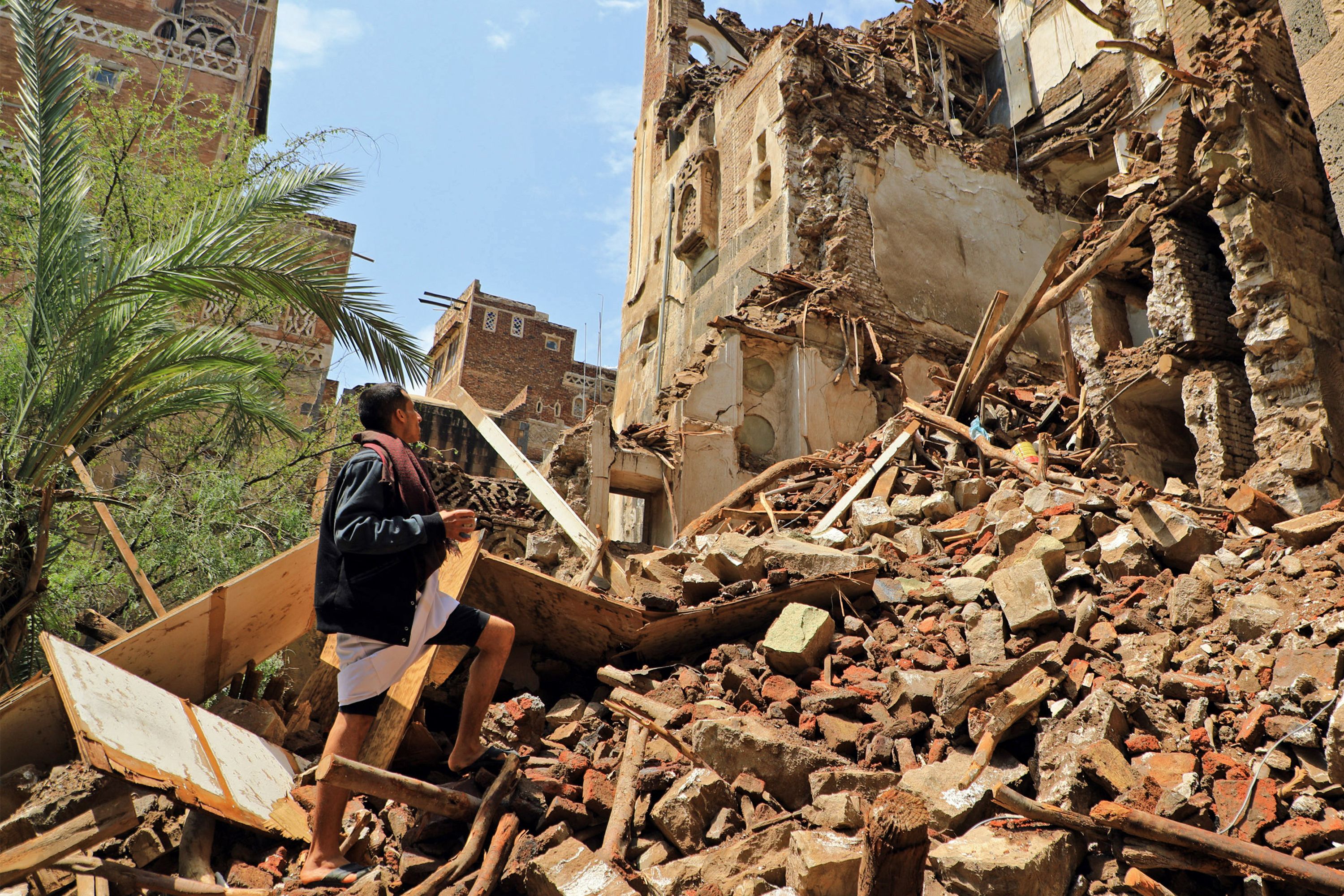 A man inspects a collapsed UNESCO-listed building in the old city of the Yemeni capital Sanaa. Credit: AFP Photo