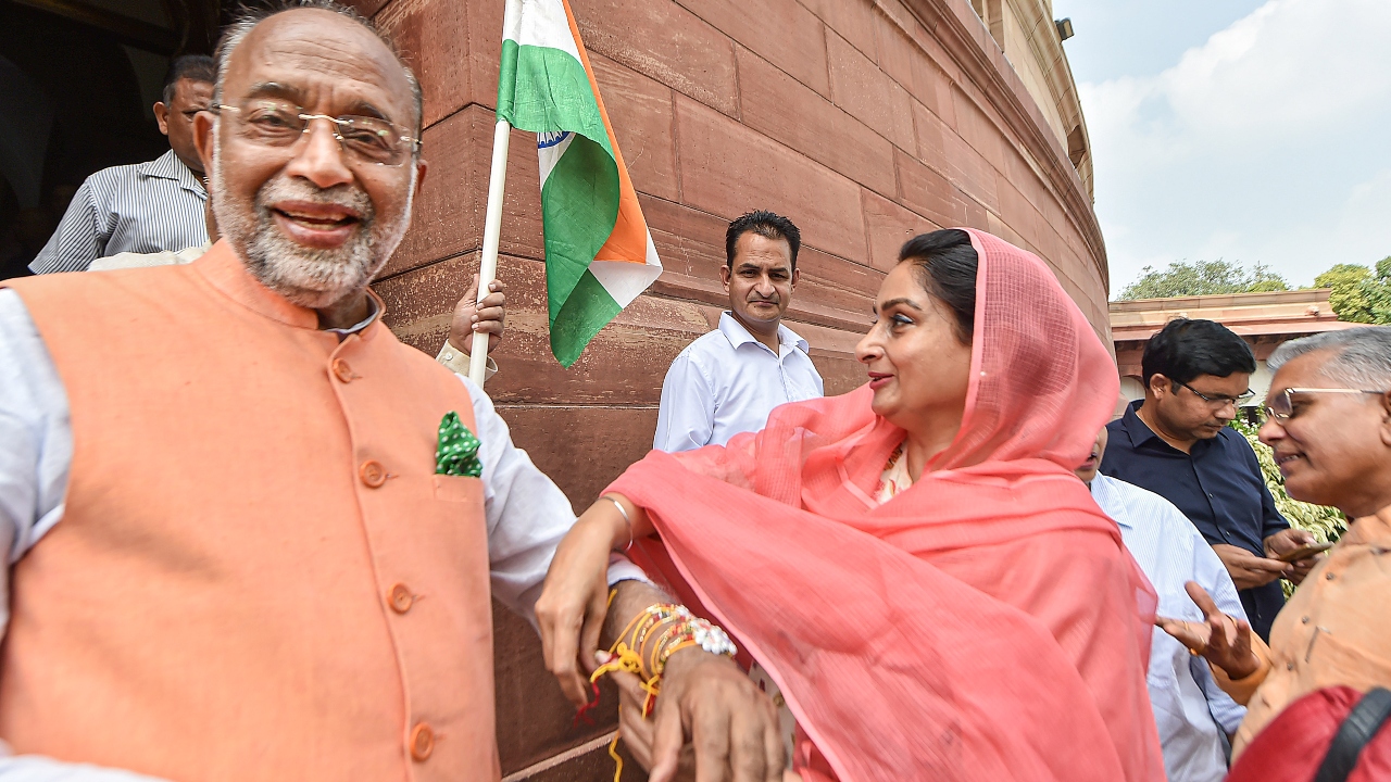SAD MP Harsimrat Kaur Badal tied a rakhi on the wrist of BJP MP Vijay Goel at Parliament during the ongoing Monsoon Session in New Delhi. Credit: PTI Photo