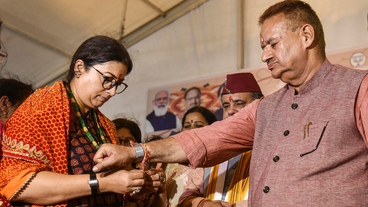 Union Minister Smriti Irani tied a rakhi on the hand of BJP leader Ganesh Joshi during an event to celebrate Raksha Bandhan in Dehradun. Credit: PTI Photo