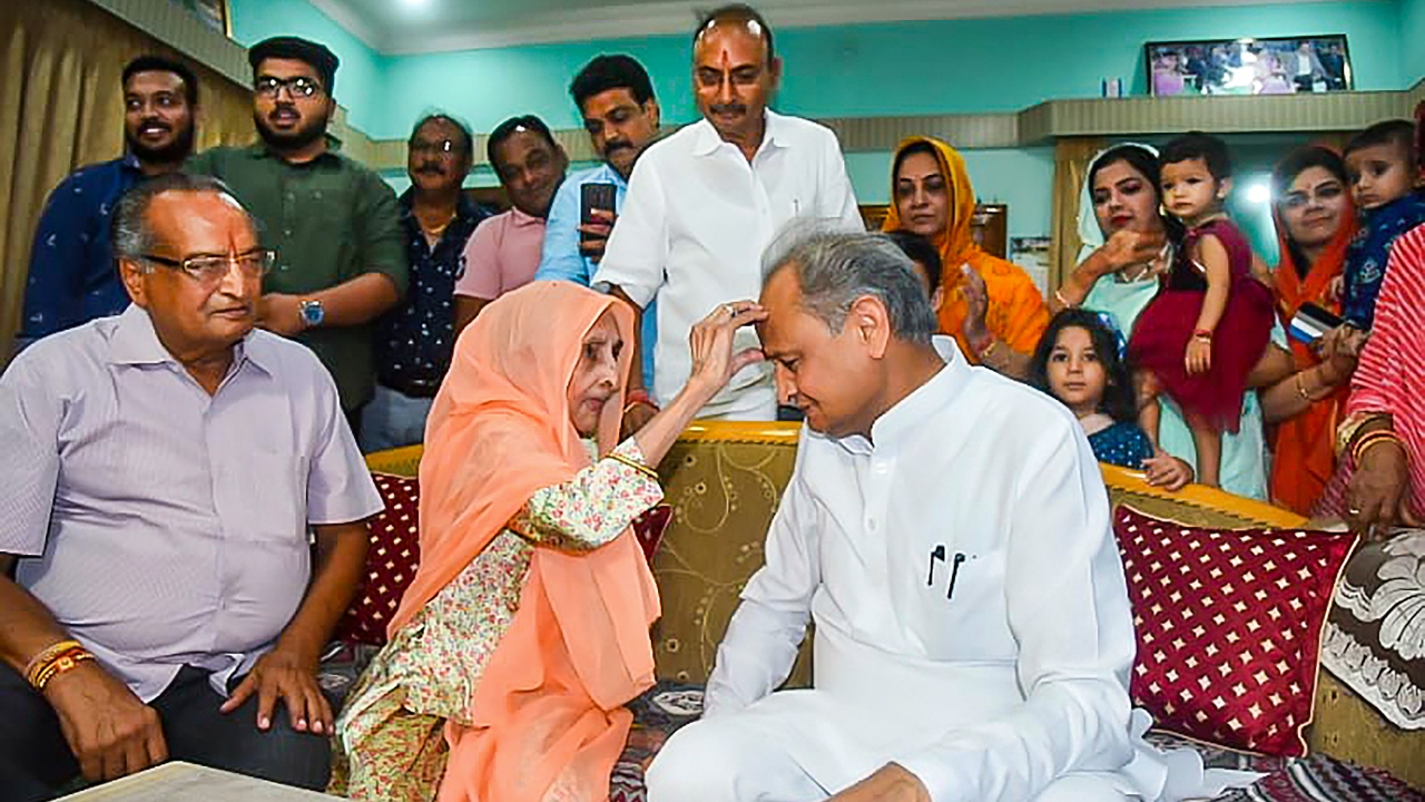 Rajasthan CM Ashok Gehlot celebrates the 'Raksha Bandhan' festival with his sister Vimla Devi, in Jodhpur. Credit: PTI Photo