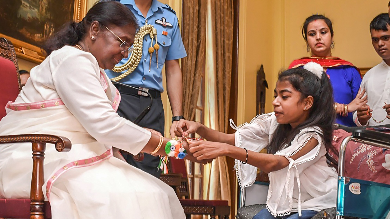 Children also tied rakhis to President Droupadi Murmu's wrist on the occasion of Raksha Bandhan at Rashtrapati Bhavan in New Delhi. Credit: PTI Photo