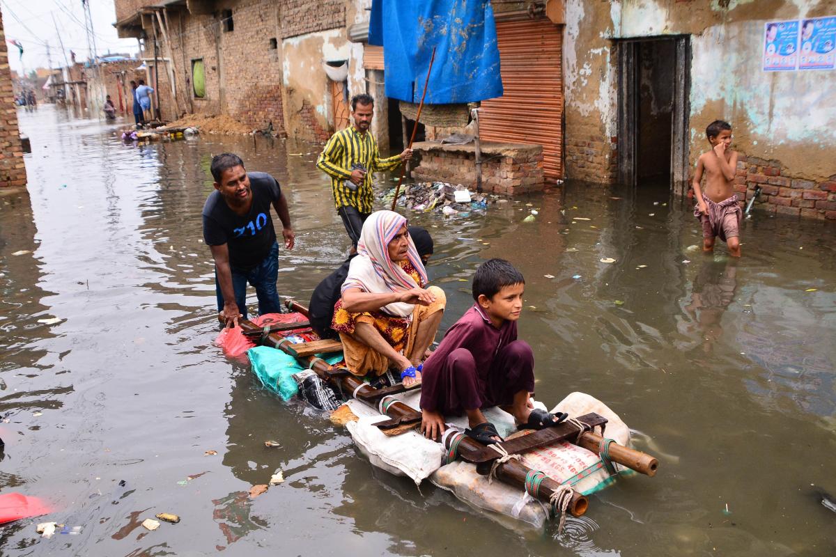 Residents use a raft to move along a waterlogged street in a residential area after a heavy monsoon rainfall in Pakistan. Credit: AFP Photo