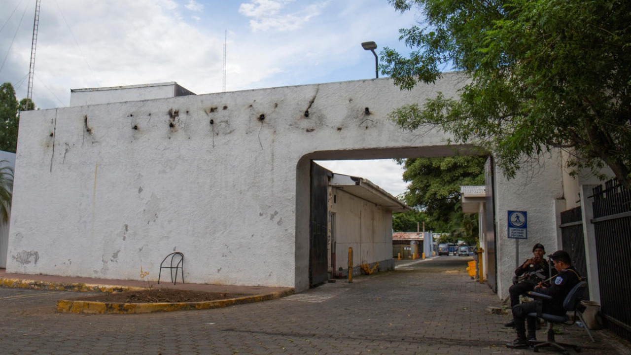 Police sit outside the facilities of La Prensa newspaper, a long-standing newspaper critical of President Daniel Ortega, after the Nicaraguan government took over the facilities to turn the space into a