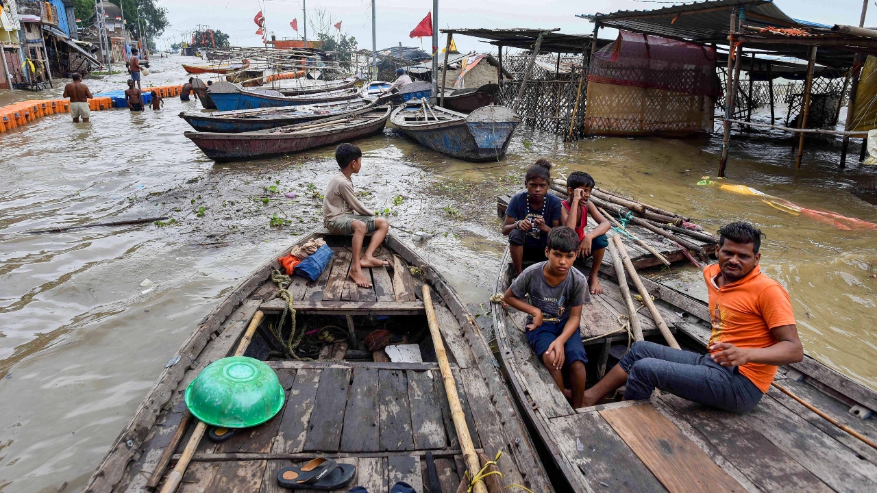 People rest in boats in the flood-hit Daraganj in Prayagraj. Credit: PTI Photo
