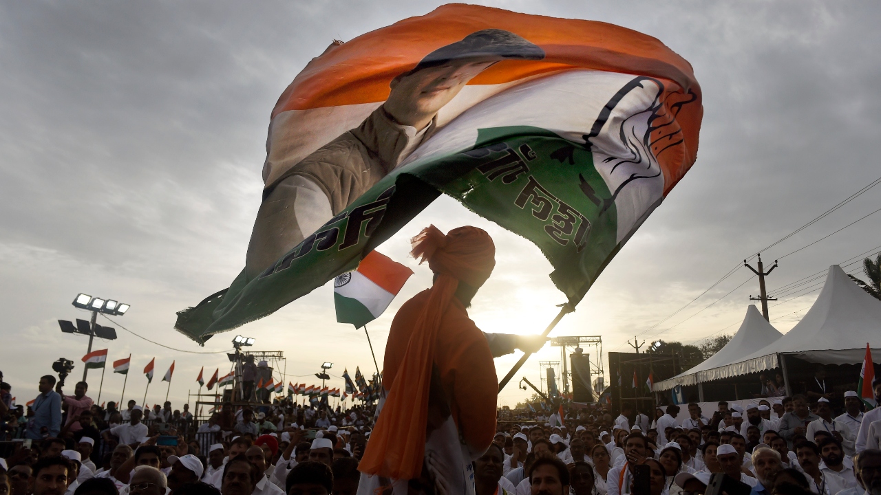 A Congress supporter waves a party flag during the launch of 'Bharat Jodo Yatra', in Kanyakumari. Credit: PTI Photo