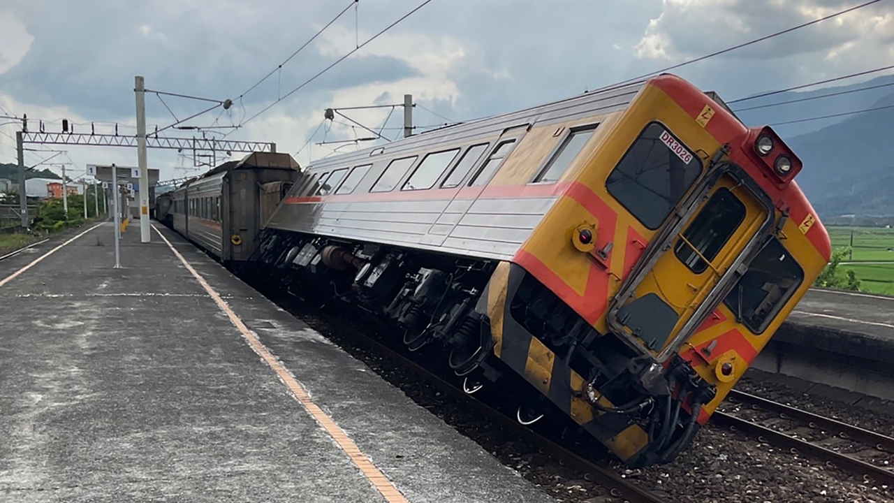 A train carriage was turned over by a fallen rain shed in a railway station in Hualien, but all passengers were safe. Credit: AFP Photo