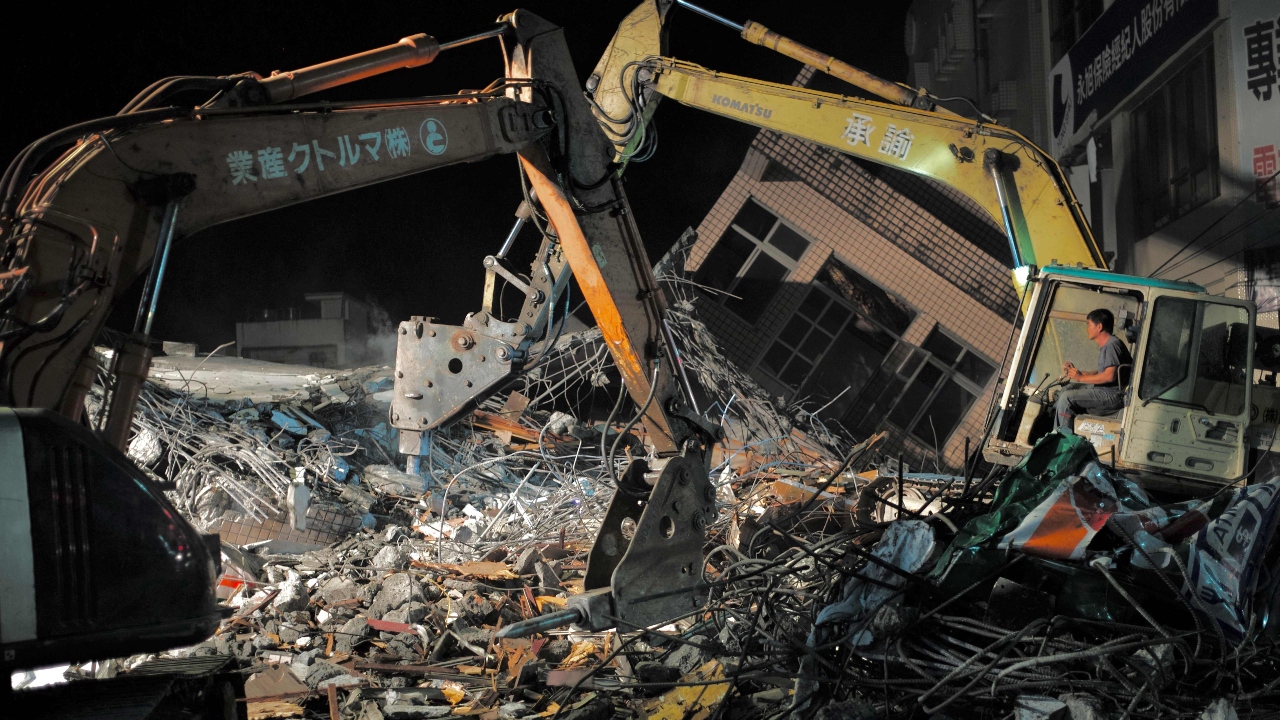 Rescue workers operate cranes to clear debries after a building collapsed in Yuli Township, Hualien county, eastern Taiwan, following the earthquake. Credit: AFP Photo