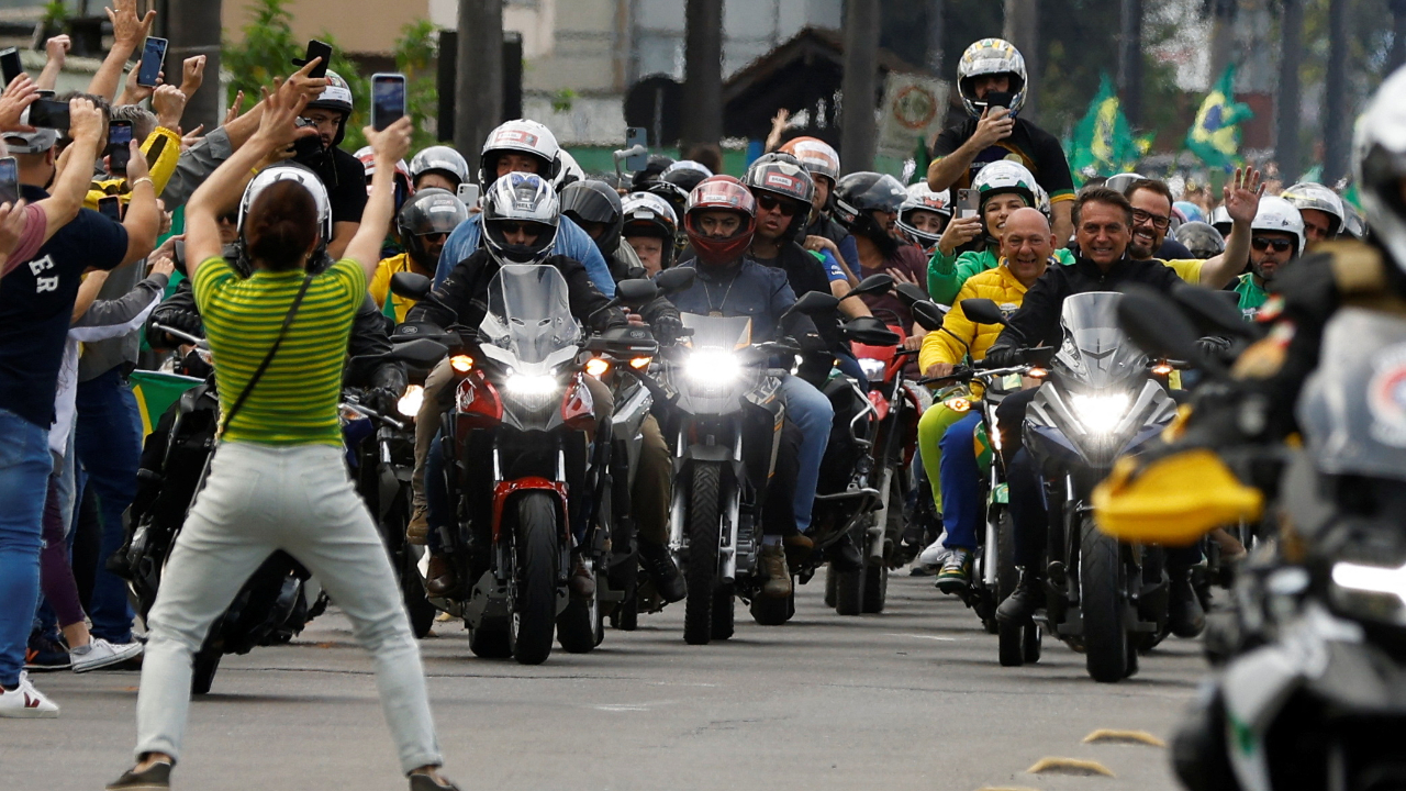 Supporters celebrate as Brazil's President and candidate for re-election Jair Bolsonaro leads a motorcade in Joinville, Brazil October 1, 2022. Credit: Reuters Photo